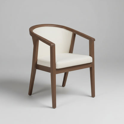 Wooden armchair with white cushion on a concrete floor