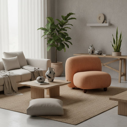 Beige armchair on a wooden floor with curtains in the background