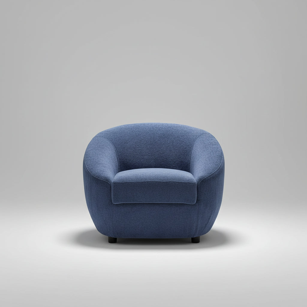 Blue armchair in a room with striped wallpaper and a plant