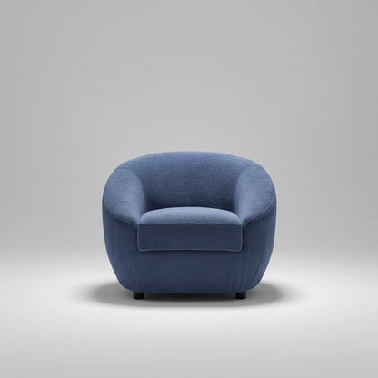 Blue armchair in a room with striped wallpaper and a plant