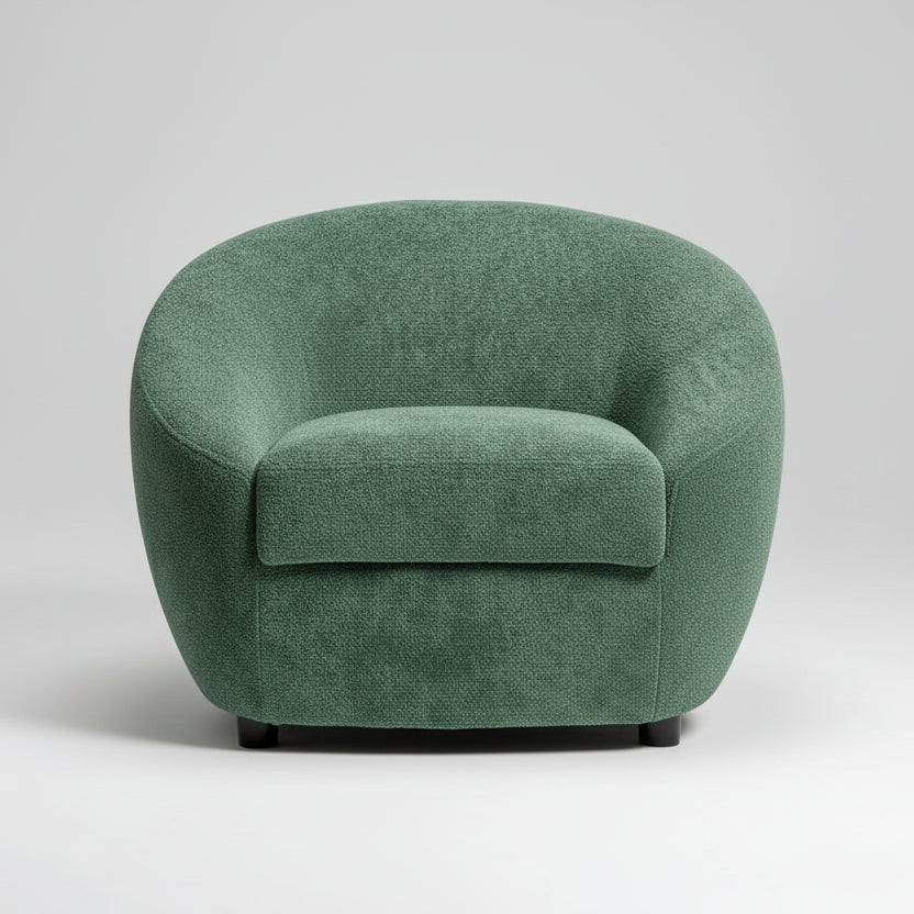 Green armchair in a room with a striped wall and a plant.