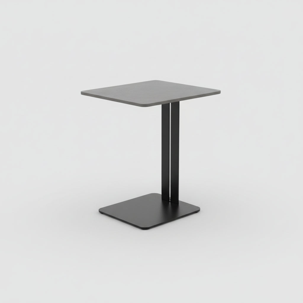 Small gray side table with black base next to a beige sofa on a wooden floor.