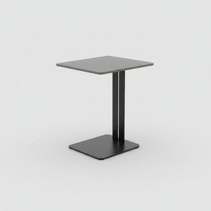 Small gray side table with black base next to a beige sofa on a wooden floor.