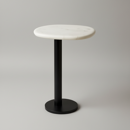 Small round table with marble top and black base on a wooden floor.