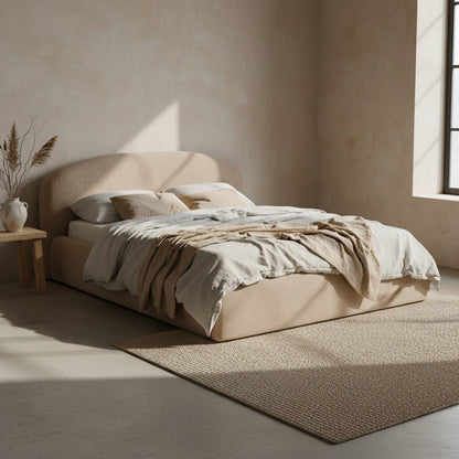 Beige upholstered bed with white mattress on a white background
