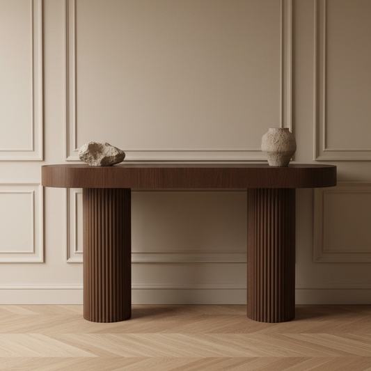 Wooden console table with decorative items against a beige wall.